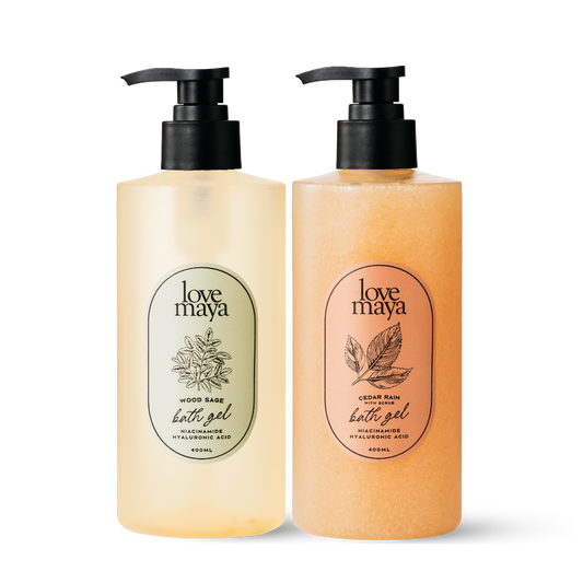 One bottle of Wood Sage Bath Gel and one bottle of Cedar Rain with Scrub Bath Gel with a transparent background